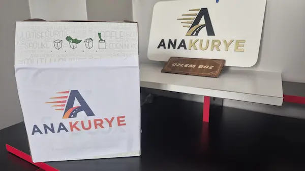 Packed parcel with Ana Kurye branding on an office desk