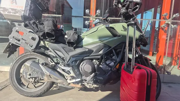Recovered red suitcase beside an Ana Kurye motorcycle before local transport