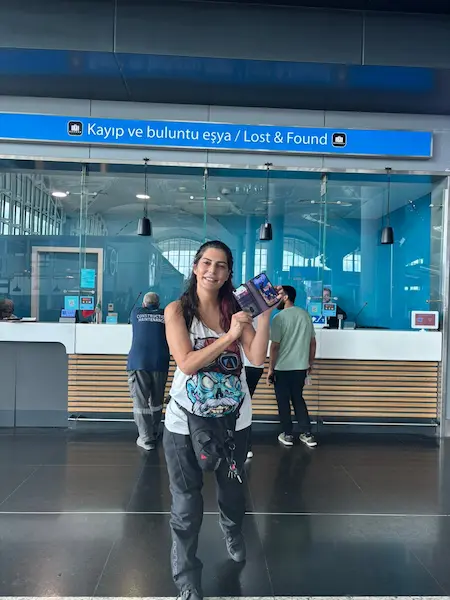 Customer holding a recovered phone at Istanbul Airport Lost and Found