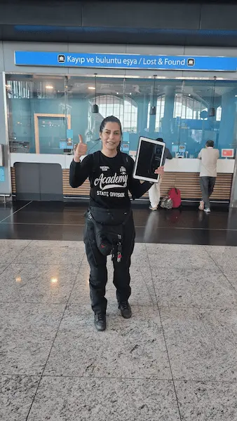 Ana Kurye representative holding the recovered iPad at Istanbul Airport IGA Lost and Found